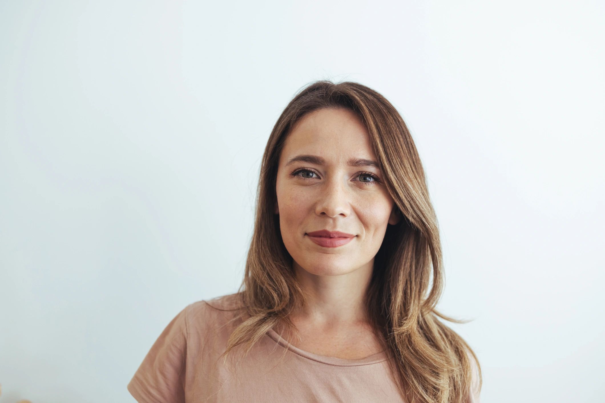 Smiling woman with light brown hair against a plain white background.