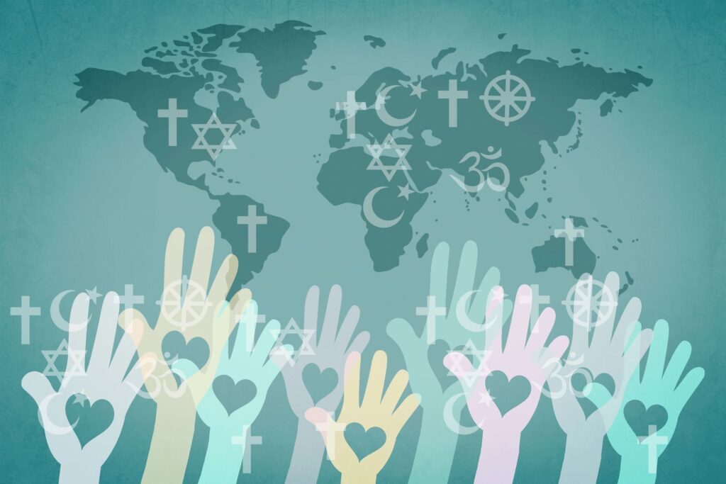 Raised hands with religious symbols over a world map.